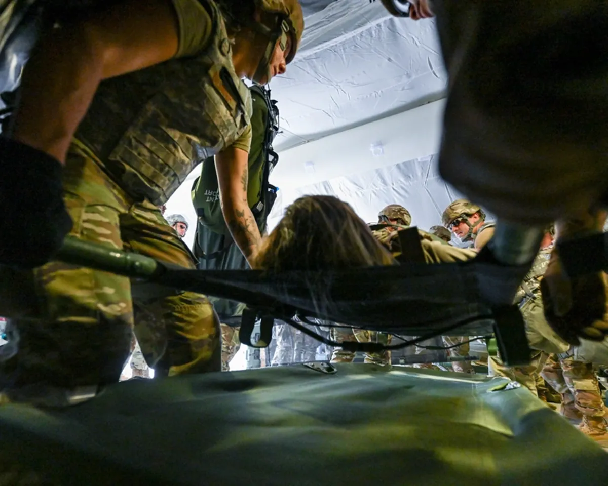 Military medics carrying a patient on a stretcher