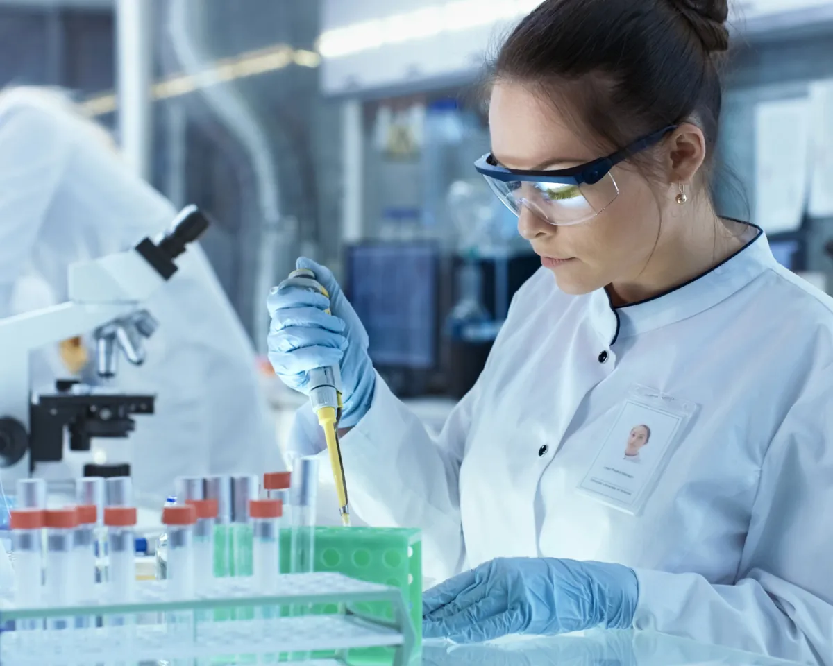 A scientist pipetting samples in a laboratory